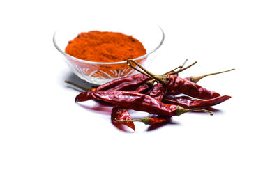 High angle view of red chili peppers on white background