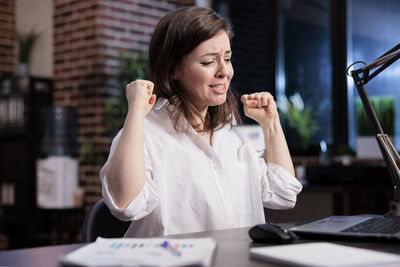 Businesswoman using laptop at table