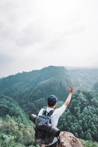 Rear view of man looking at mountains