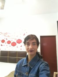 Portrait of smiling woman at home