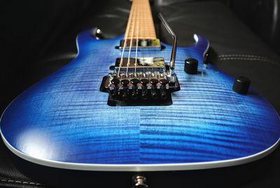 Close-up of guitar against black background
