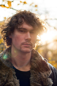 Portrait of young man looking away outdoors