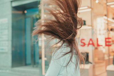 Woman tossing hair while standing outdoors