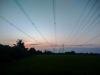 Scenic view of silhouette field against sky during sunset