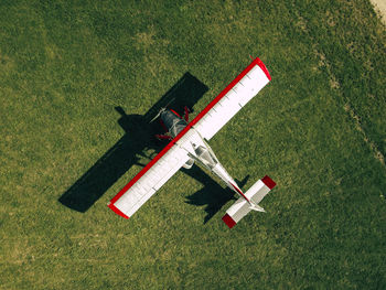 High angle view of biplane on grassy field