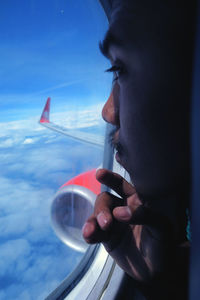 Close-up portrait of woman against sky