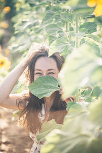 Portrait of smiling woman with leaves