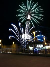 Low angle view of firework display at night