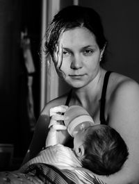 Portrait of happy mother with baby at home