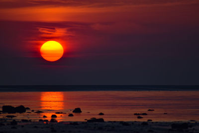 Scenic view of sea against orange sky