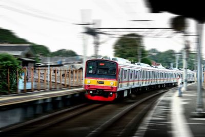 Train at railroad station platform against sky