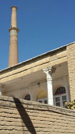 Low angle view of built structure against clear blue sky