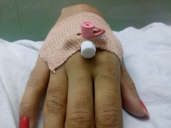 Close-up of woman with iv drip on hand at hospital