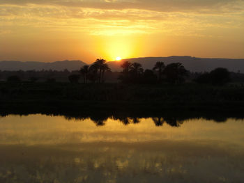 Scenic view of lake at sunset