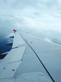 Close-up of airplane wing against sky