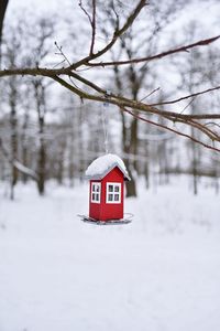 House on snow covered tree against sky