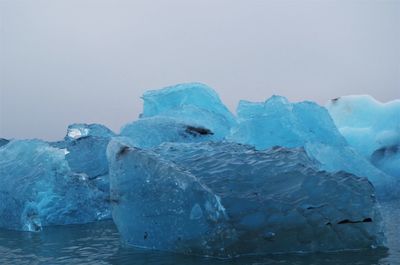 Close-up of frozen sea against sky