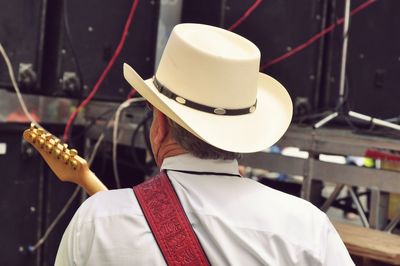 Rear view of man with guitar