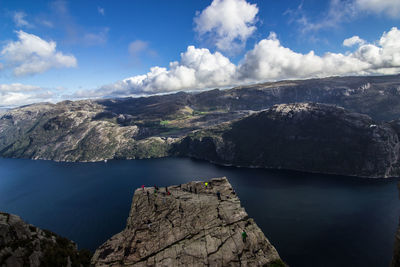 Scenic view of river and mountains against sky