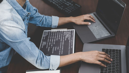 Low angle view of man using laptop on table