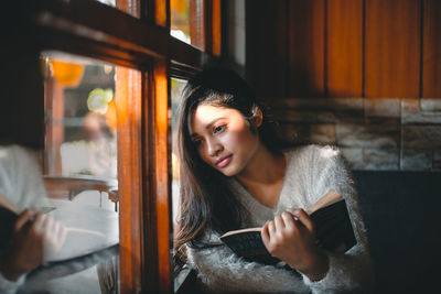 Portrait of young woman using mobile phone