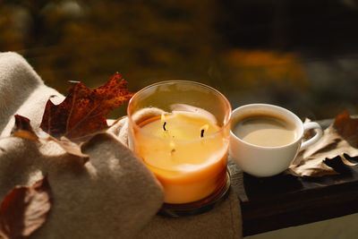 Sweater, candle, hot coffee and autumn decor. autumn home decor