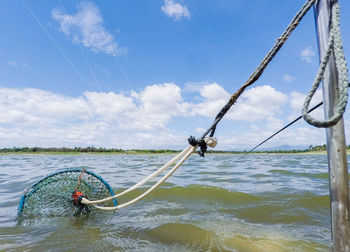 Crab pot tied from pole in lake