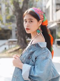 Portrait of beautiful young woman standing outdoors