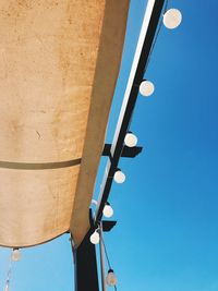 Low angle view of communications tower against clear blue sky