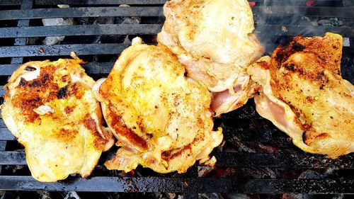 High angle view of meat on barbecue grill