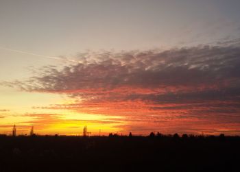 Silhouette landscape against sky during sunset