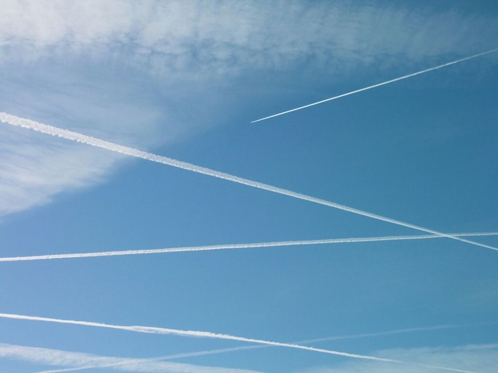 blue, low angle view, vapor trail, sky, cloud - sky, flying, transportation, airplane, nature, day, beauty in nature, part of, cloud, outdoors, no people, scenics, tranquility, air vehicle, mid-air, white color