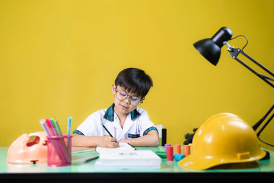 Full length portrait of a girl sitting on table