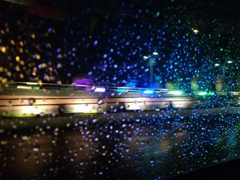 Defocused image of illuminated lights at night