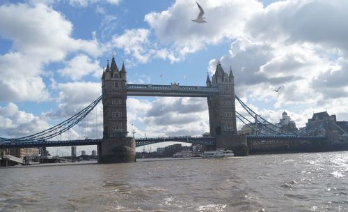 View of bridge over river against cloudy sky