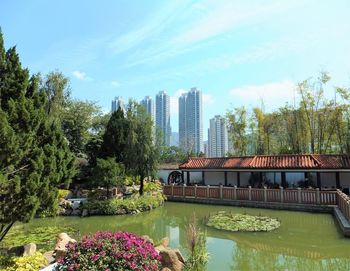 View of trees by lake against sky