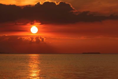 Scenic view of sea against romantic sky at sunset