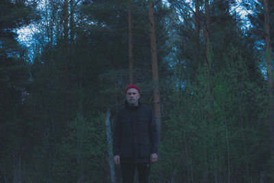 Portrait of man standing in forest