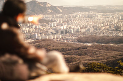 Panoramic view on seoul city from bukhansan mountain with a person