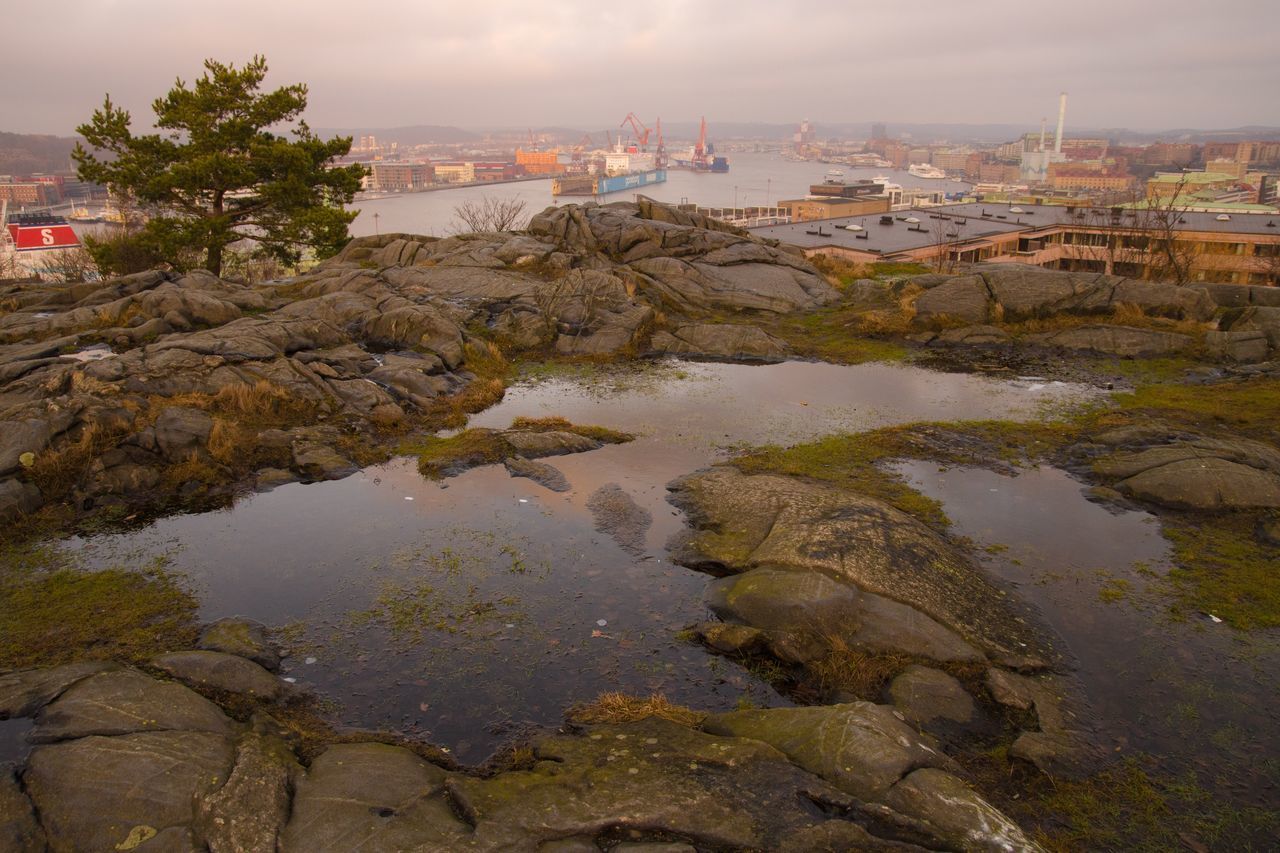 VIEW OF RIVER WITH CITY IN BACKGROUND