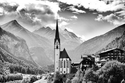 Church and buildings against mountains and sky