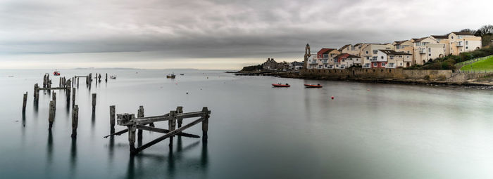 Scenic view of sea and buildings against sky