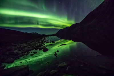 Scenic view of mountain against sky at night