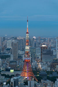 Illuminated cityscape against sky