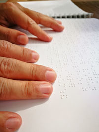 Midsection of man reading book