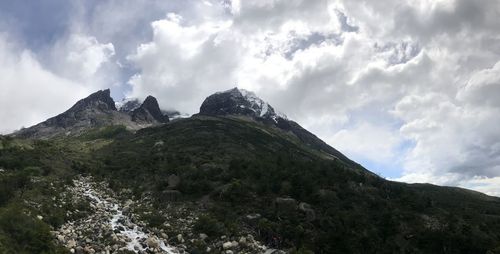 Scenic view of mountains against cloudy sky