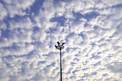 Low angle view of street light against cloudy sky