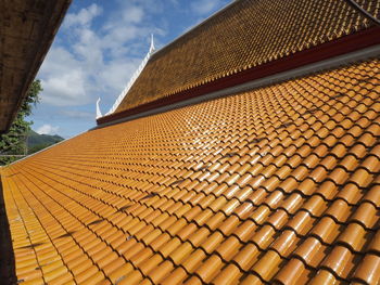 Low angle view of roof tiles against sky