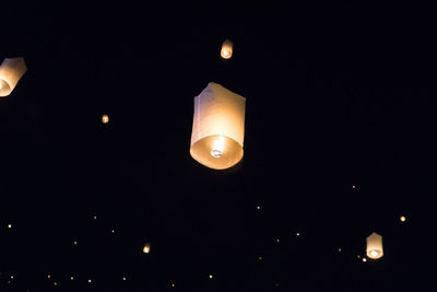 Low angle view of illuminated lantern against sky at night