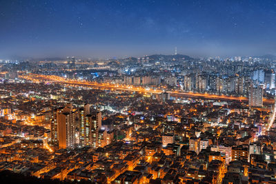 High angle view of city lit up at night